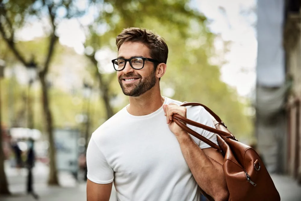 Man with beard carying a bag
