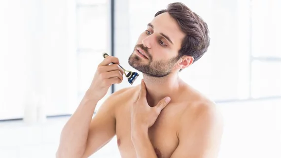 Man shaving in the mirror