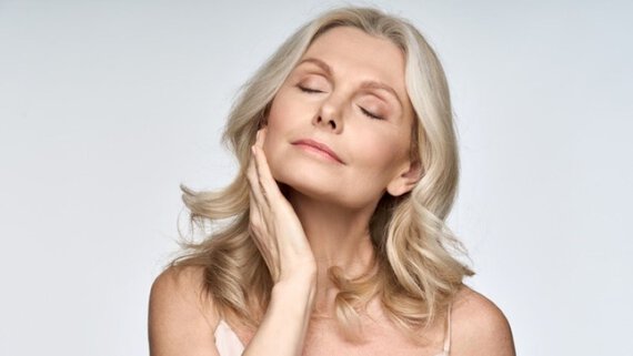 mature woman touching her face
