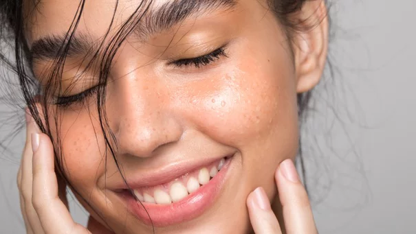 women touching her face with liquide