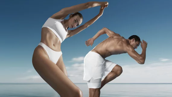 man and woman standing and stretching